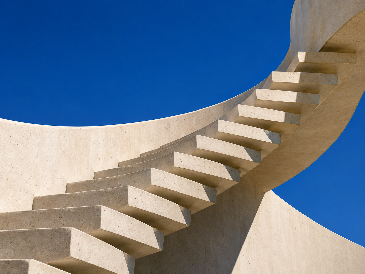 Sunlit concrete steps rising into a clear blue sky